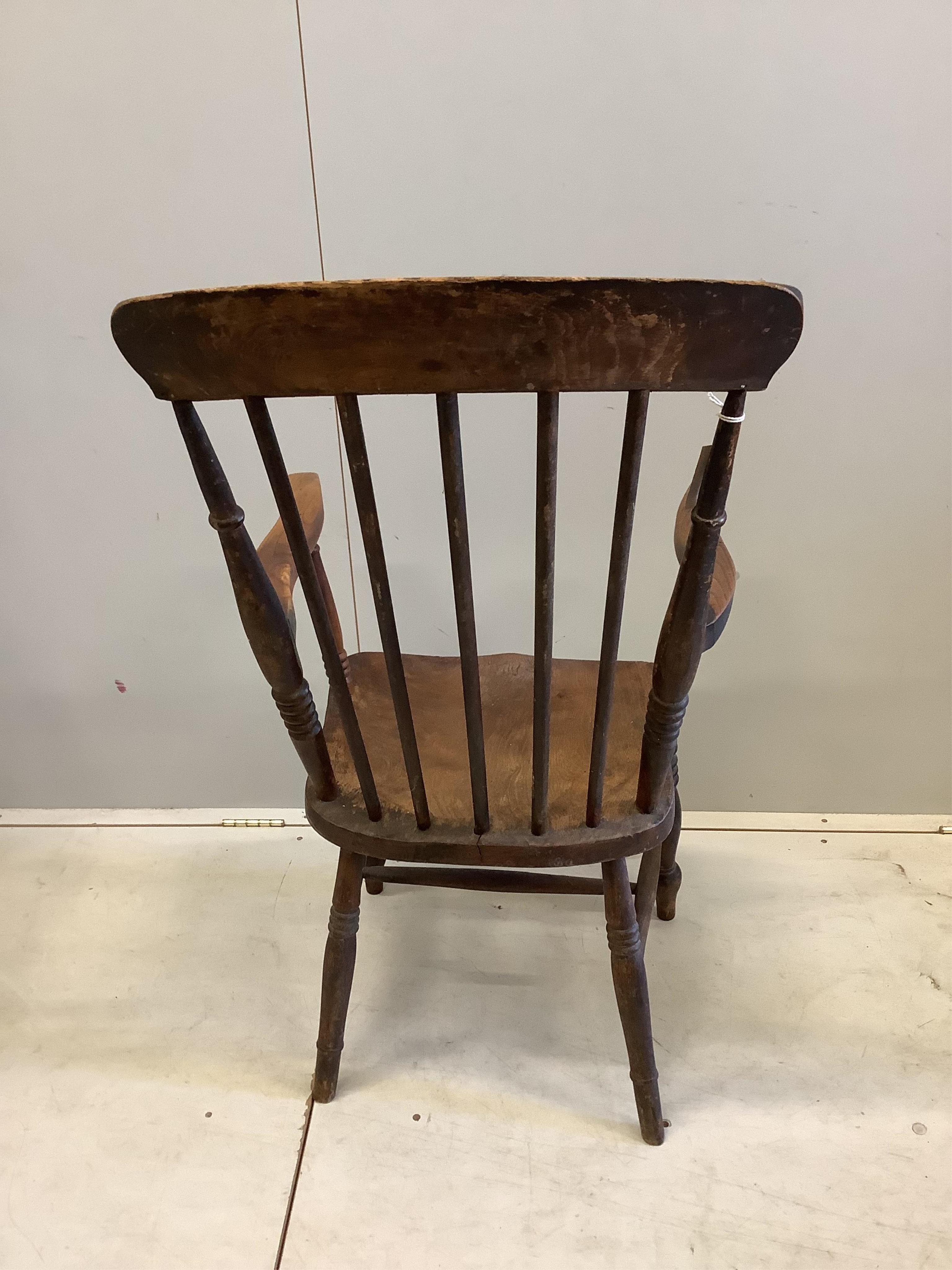 Two Victorian elm and beech Windsor comb back armchairs, larger width 58cm, depth 43cm, height 111cm